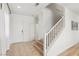Neutral entryway with tiled floors and staircase with white railing at 3194 Lapis Beach Dr, Las Vegas, NV 89117