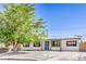Charming single-story home featuring a minimalist landscaped yard, painted white stucco, and a welcoming blue front door at 333 Rossmoyne Ave, North Las Vegas, NV 89030