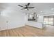 Bright, open-concept living room featuring hardwood floors and adjacent modern kitchen with large island at 333 Rossmoyne Ave, North Las Vegas, NV 89030