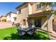 A backyard with an outdoor dining area and a covered patio at 3553 Terneza Ave, North Las Vegas, NV 89081