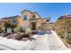 Charming two-story stucco home featuring a desert landscape, tile roof, and attached two-car garage at 3553 Terneza Ave, North Las Vegas, NV 89081