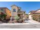 Charming two-story stucco home featuring a desert landscape, tile roof, and attached two-car garage at 3553 Terneza Ave, North Las Vegas, NV 89081
