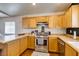Updated kitchen featuring wooden cabinets, stainless steel appliances, and hardwood floors at 3553 Terneza Ave, North Las Vegas, NV 89081