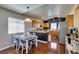 Eat-in kitchen area with wood cabinets, stainless steel appliances, and hardwood floors at 3553 Terneza Ave, North Las Vegas, NV 89081