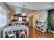 Open-concept kitchen features an eat-in area, wooden cabinets, stainless steel appliances, and hardwood floors at 3553 Terneza Ave, North Las Vegas, NV 89081