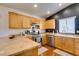 Updated kitchen featuring wooden cabinets, stainless steel appliances, and hardwood floors at 3553 Terneza Ave, North Las Vegas, NV 89081
