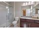 Bathroom features a glass shower, toilet, granite-look vanity, and decorative lighting at 406 Gracious Way, Henderson, NV 89011