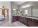 Bathroom features a dual sink vanity with granite countertops that connects to the bedroom at 406 Gracious Way, Henderson, NV 89011