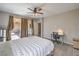 Spacious bedroom with a bed, desk and chair, and sliding glass doors leading to an outdoor patio at 406 Gracious Way, Henderson, NV 89011