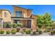 Inviting two-story home featuring desert landscaping, a cozy porch, and an upper-level balcony on a sunny day at 406 Gracious Way, Henderson, NV 89011