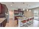 Modern kitchen with stainless steel appliances, island with seating, and hardwood floors at 406 Gracious Way, Henderson, NV 89011
