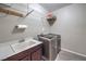 Bright laundry room with washer, dryer, sink, and shelving at 406 Gracious Way, Henderson, NV 89011