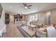 Open-concept living room and kitchen with wood flooring and stylish furnishings at 406 Gracious Way, Henderson, NV 89011