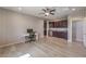 Open-concept living space with mini kitchen, desk, and wood-look flooring at 406 Gracious Way, Henderson, NV 89011