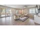 Light-filled living room showcases hardwood floors, slider doors to outdoor patio, and modern decor at 406 Gracious Way, Henderson, NV 89011