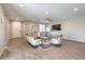 Bright living room featuring hardwood floors, ceiling fan, with easy access to other living spaces at 406 Gracious Way, Henderson, NV 89011