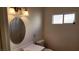 Bathroom features vanity, toilet and decorative round mirror at 4285 El Como Way, Las Vegas, NV 89121
