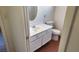 Bright bathroom features a white single sink vanity, toilet, and round mirror at 4285 El Como Way, Las Vegas, NV 89121