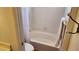 Bathroom showcasing a tub, toilet, and white tile at 4285 El Como Way, Las Vegas, NV 89121