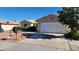Charming home features a two car garage, desert landscaping, and front yard at 4285 El Como Way, Las Vegas, NV 89121