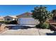 Charming home features a two car garage, desert landscaping, and front yard at 4285 El Como Way, Las Vegas, NV 89121