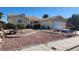 Charming single-story home with desert landscaping, a red-tile roof, and an attached two-car garage at 4285 El Como Way, Las Vegas, NV 89121