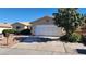View of the home's front exterior, highlighting the two car garage, and low maintenance landscaping at 4285 El Como Way, Las Vegas, NV 89121