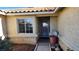 The home's entry features a secure gate, a window, and desert landscaping at 4285 El Como Way, Las Vegas, NV 89121