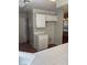 Kitchen with white cabinets, tile countertop and view into the dining room at 4285 El Como Way, Las Vegas, NV 89121
