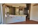 An open kitchen with tile countertops and a breakfast bar, perfect for casual dining and entertaining at 4285 El Como Way, Las Vegas, NV 89121