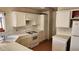 Bright kitchen with white appliances, countertops, and cabinetry, offering a clean and classic aesthetic at 4285 El Como Way, Las Vegas, NV 89121