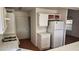 Well-lit kitchen with appliances and an adjacent door leading outside, facilitating easy access for groceries at 4285 El Como Way, Las Vegas, NV 89121