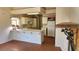Bright kitchen featuring an island, tile flooring, white cabinets, and essential appliances at 4285 El Como Way, Las Vegas, NV 89121
