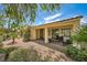 An inviting covered patio with chairs, perfect for relaxing in the landscaped backyard at 4552 Largo Cantata St, Las Vegas, NV 89135