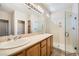 Bright bathroom boasts a double sink vanity and a glass-enclosed shower at 4552 Largo Cantata St, Las Vegas, NV 89135
