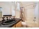 Bathroom with black countertop sink and shower-tub combination at 4552 Largo Cantata St, Las Vegas, NV 89135