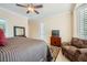 Cozy bedroom featuring a ceiling fan, neutral walls, and comfortable chair at 4552 Largo Cantata St, Las Vegas, NV 89135