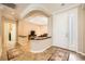 Warm and inviting foyer features tiled floors, archways, and a half wall to living area at 4552 Largo Cantata St, Las Vegas, NV 89135