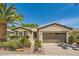 Charming single-story home featuring desert landscaping, mature palm tree, and attached two-car garage at 4552 Largo Cantata St, Las Vegas, NV 89135