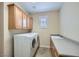 Bright laundry room with washer, dryer, sink and storage cabinets at 4552 Largo Cantata St, Las Vegas, NV 89135