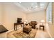 A cozy living area with comfortable seating, a TV, and natural light from shuttered windows at 4552 Largo Cantata St, Las Vegas, NV 89135