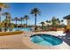 Beautiful outdoor pool and hot tub area with palm trees and desert landscaping, a true oasis at 4552 Largo Cantata St, Las Vegas, NV 89135