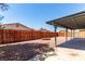 Backyard featuring a brick fire pit, covered patio and privacy fence at 4745 Madrigal Way, Las Vegas, NV 89122