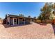 Spacious backyard featuring a brick fire pit and covered patio at 4745 Madrigal Way, Las Vegas, NV 89122