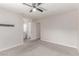 Spacious bedroom featuring ceiling fan, light gray walls, and gray carpet at 4745 Madrigal Way, Las Vegas, NV 89122