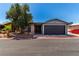 Attractive single-story home with gray paint, rock details, and attached two-car garage at 4745 Madrigal Way, Las Vegas, NV 89122