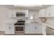 Stylish kitchen featuring stainless steel appliances and white cabinetry at 4745 Madrigal Way, Las Vegas, NV 89122