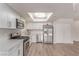 Bright kitchen featuring stainless steel appliances, white cabinets, and an updated light fixture at 4745 Madrigal Way, Las Vegas, NV 89122