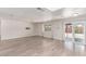 Spacious living room with light wood floors, a large window and a sliding glass door at 4745 Madrigal Way, Las Vegas, NV 89122