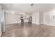 Open-concept living space featuring wood-look flooring, natural light, and kitchen access at 4745 Madrigal Way, Las Vegas, NV 89122